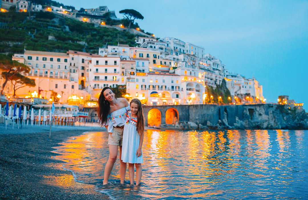 Amalfi, Italy Mother and daughter on the beach at dusk in Amalfi, Italy