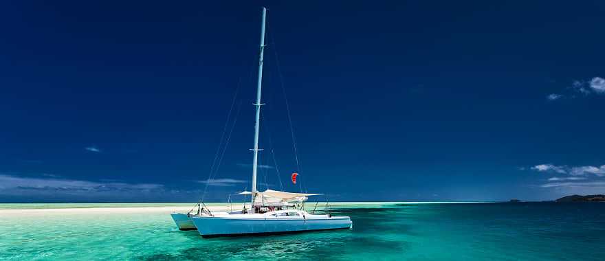 White catamaran on tropical island in Fiji