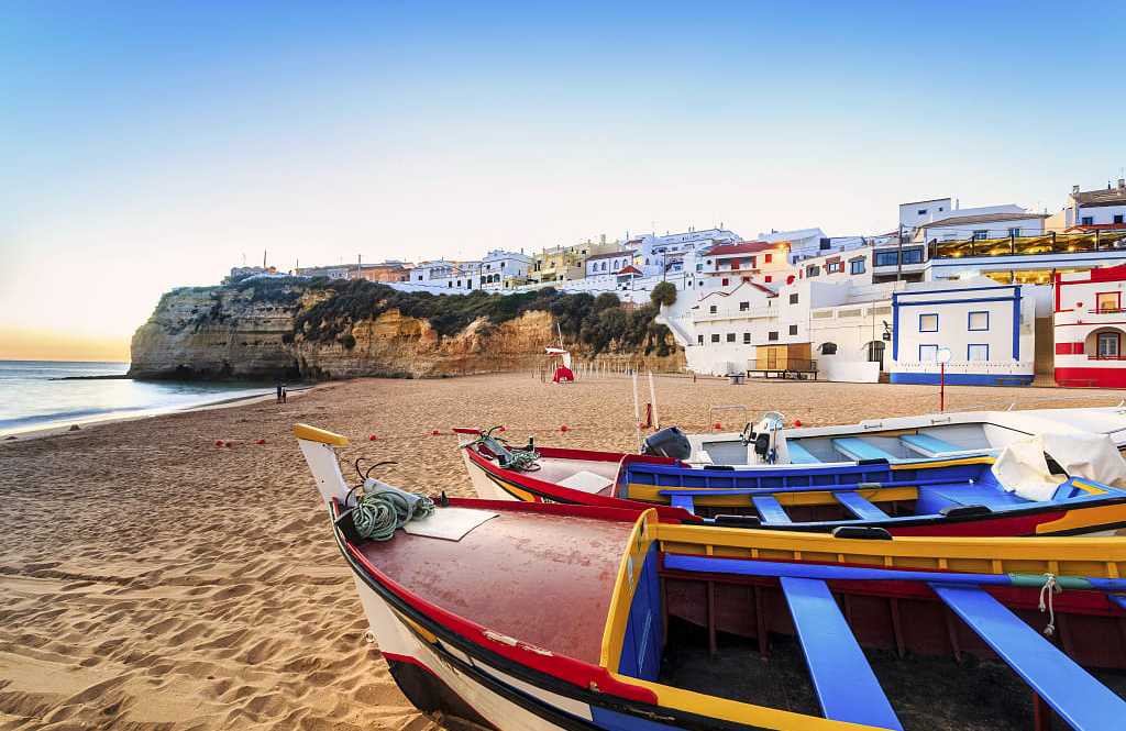 Beautiful beach with colorful boats in Carvoeiro in the Algarve region of  Portugal