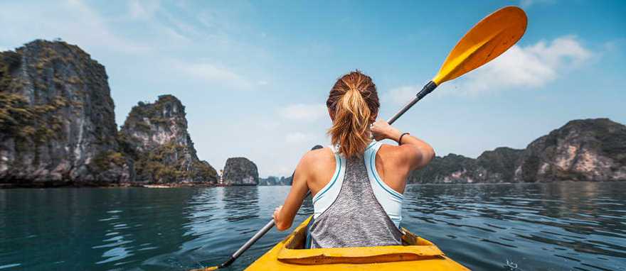 Woman kayaking in Ha Long Bay, Vietnam