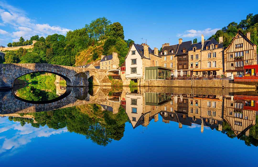 The old stone bridge and medieval houses in Port Dinan town, France