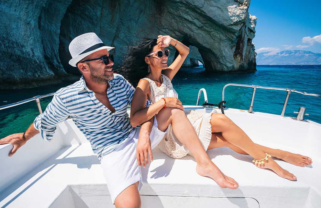 Couple on a luxury yacht sailing the islands in Greece