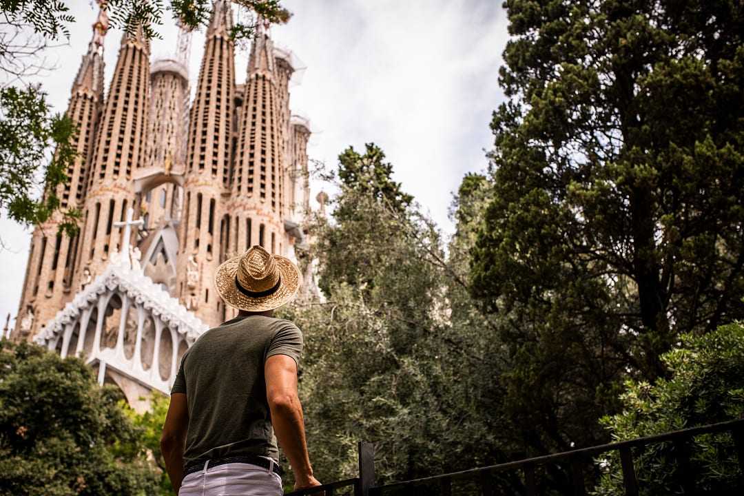 Man looking up at La Sagrada Familia in Barcelona, Spain