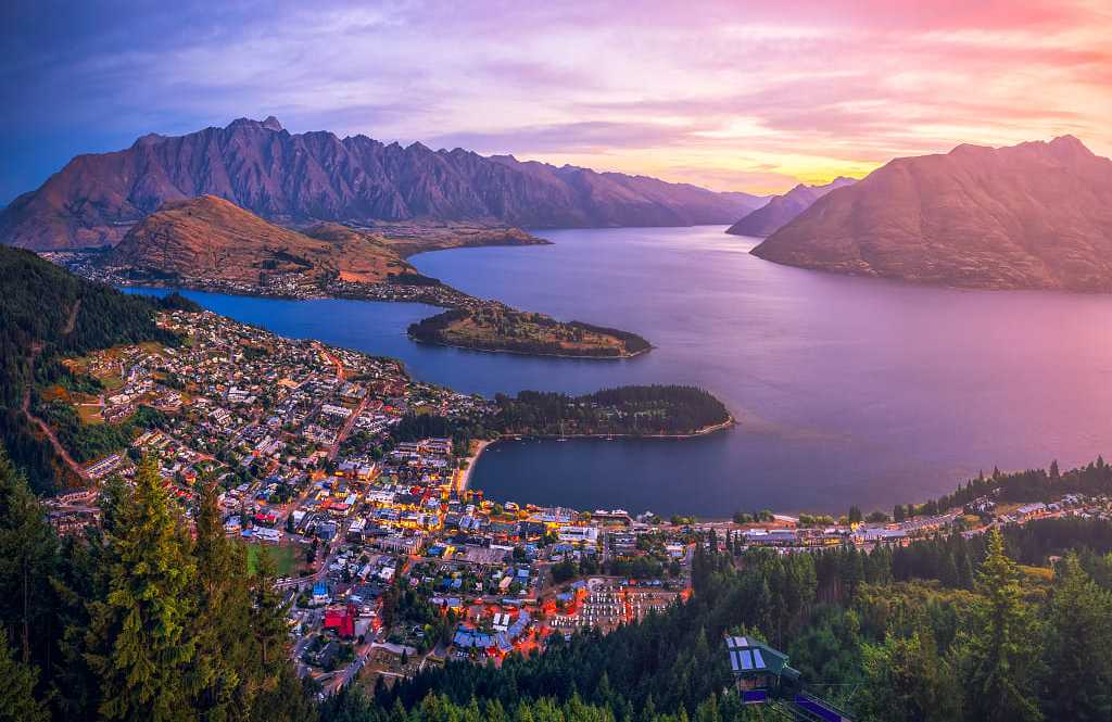 Aerial view of Queenstown at twilight with Lake Wakatipu and The Remarkable Mountains in New Zealand.
