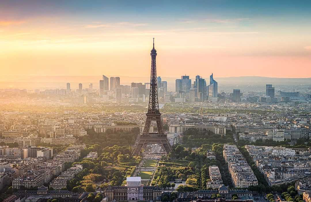 Paris, France  The Eiffel Tower stands tall over Paris with golden sunset hues.
