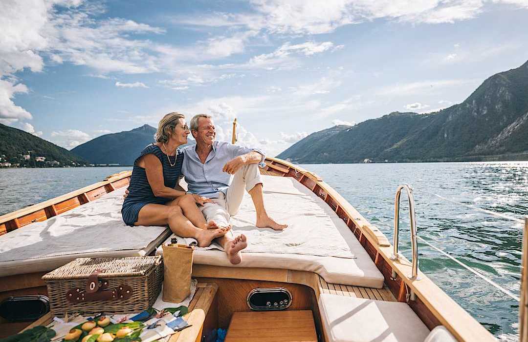 Private boat cruise in Switzerland Luxury senior couple cruising on a private boat on a lake in Switzerland