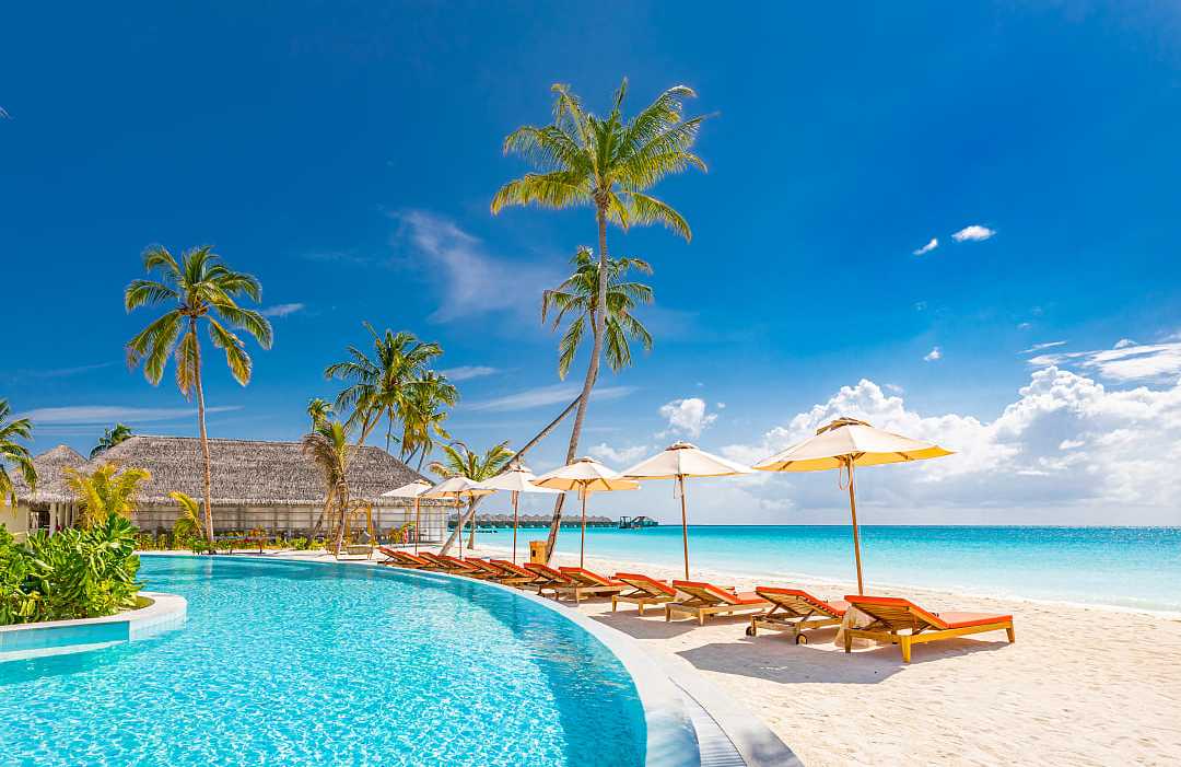 Luxury resort pool by the beach in the Maldives