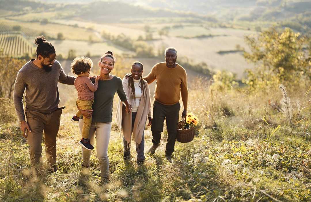 Multi-generational family exploring vineyards during the fall Multi-generational family exploring vineyards during the fall