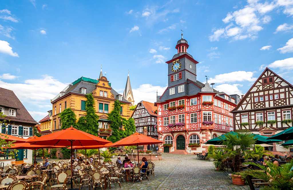 Cafes with outdoor seating and the half-timbered buildings in the market square of Heppenheim, Germany