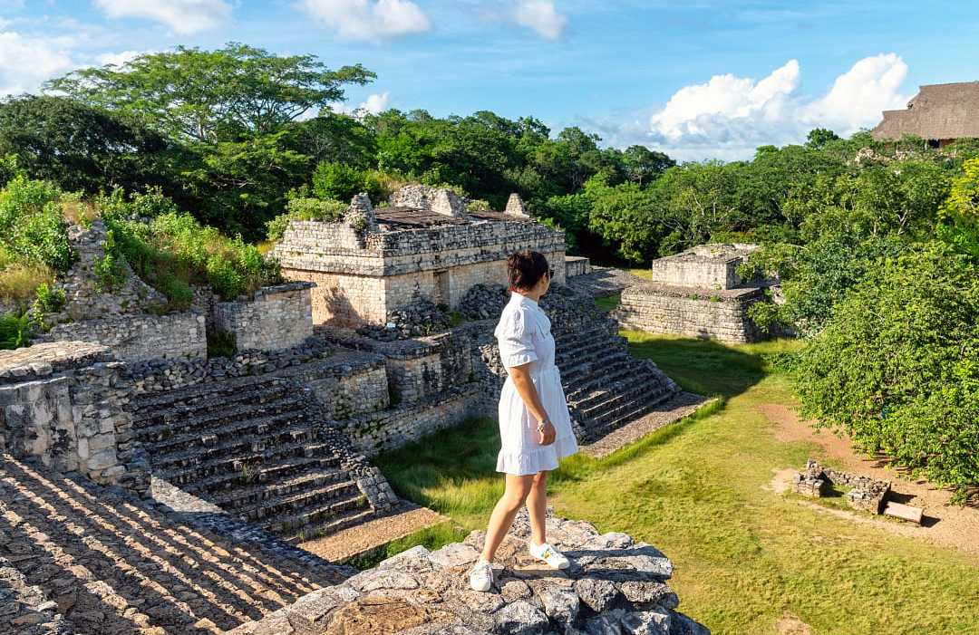 Woman looking out at Mayan ruins in Yucatan, Mexico