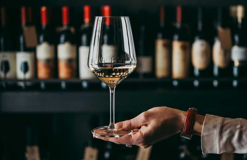 Woman holding wine glass showing the legs Woman holding wine glass showing the legs