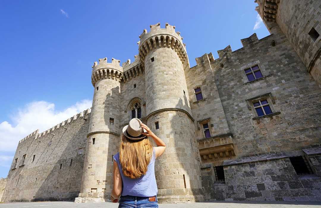 Palace of the Grand Master of the Knights in Rhodes, Greece Woman visiting the Palace of the Grand Master of the Knights in Rhodes, Greece