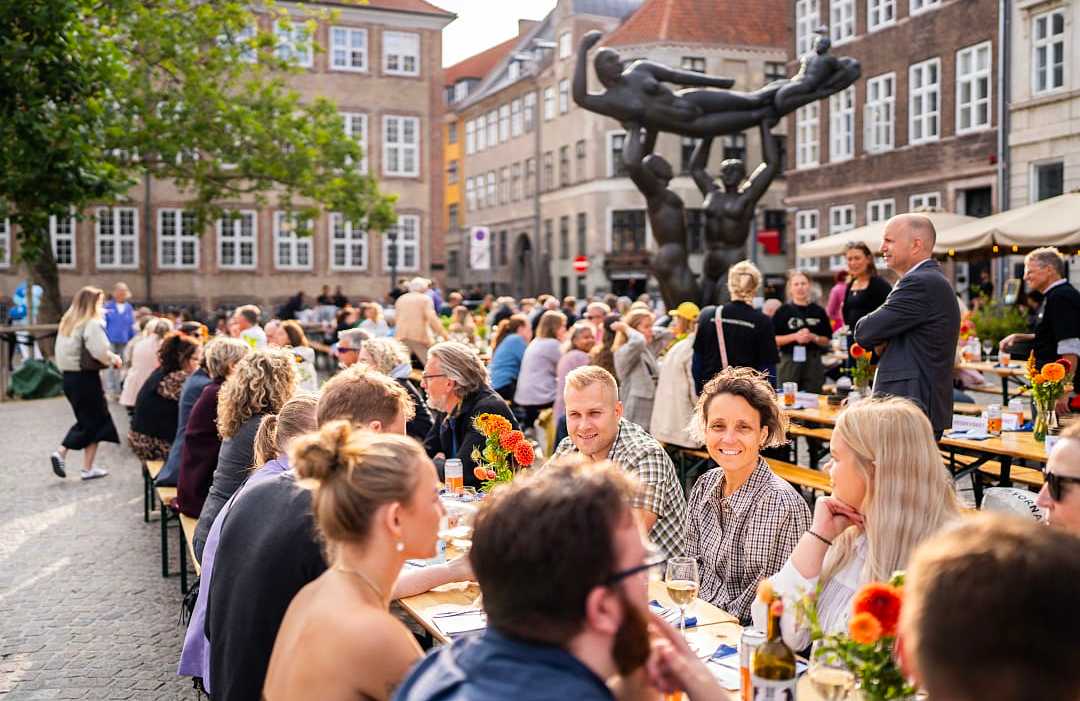 Copenhagen Cooking and Food Festival. Photo courtesy of Sphie Due / Food Organization of Denmark Outdoor dining scene at Copenhagen Cooking and Food Festival, people enjoying food in a lively square.