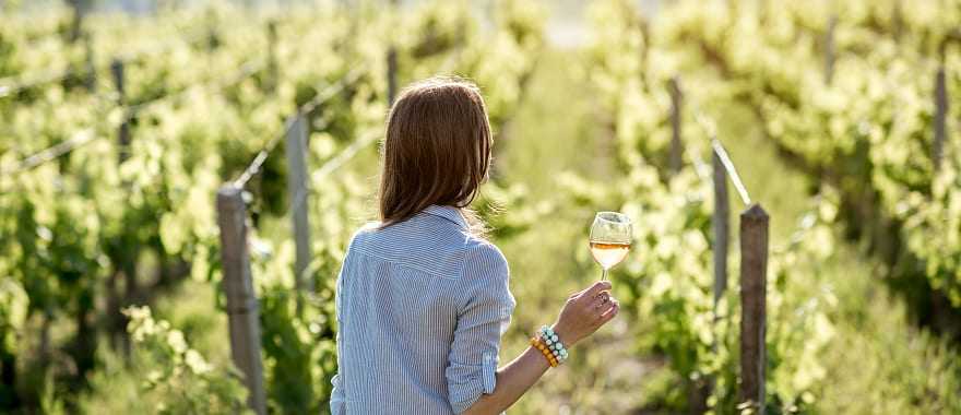 A woman holding a glass of wine in Bordeaux, France