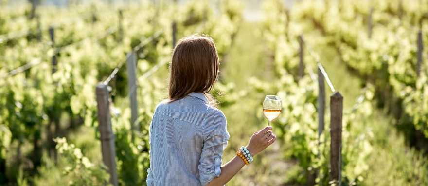 A woman holding a glass of wine in Bordeaux, France
