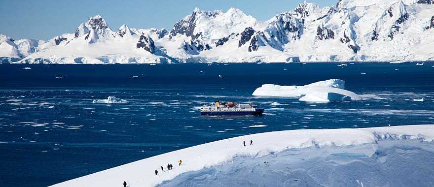 Tourists hiking on glacier during an excursion in Antarctica