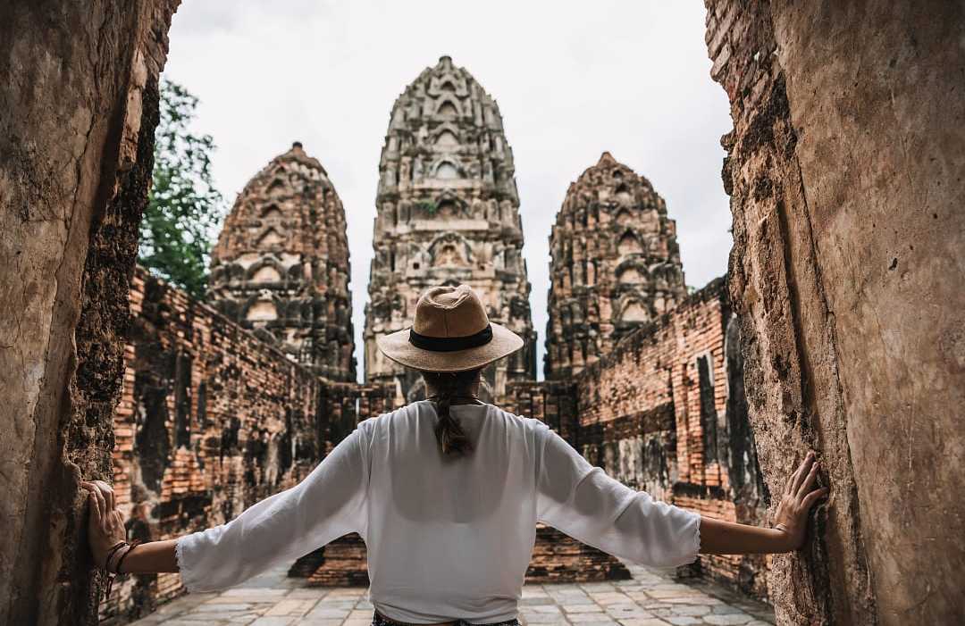 raveler explores the ancient Khmer-style temple ruins of Wat Si Sawai in Sukhothai, Thailand.