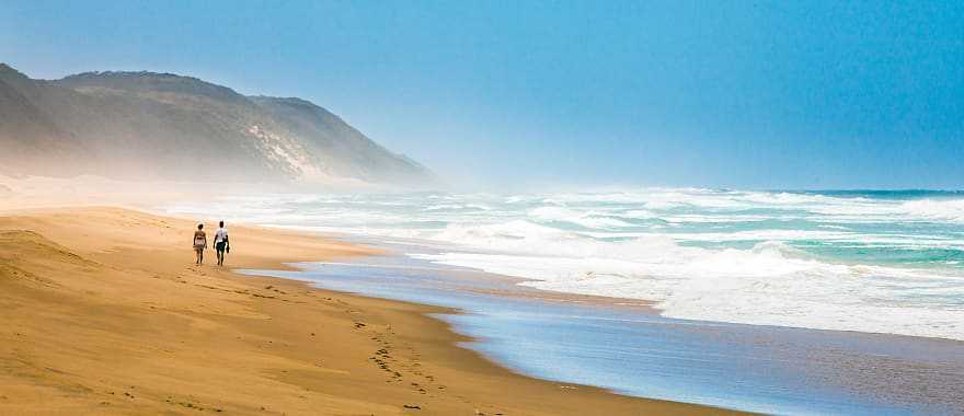 Couple walking on the beach in Saint Lucia, South Africa