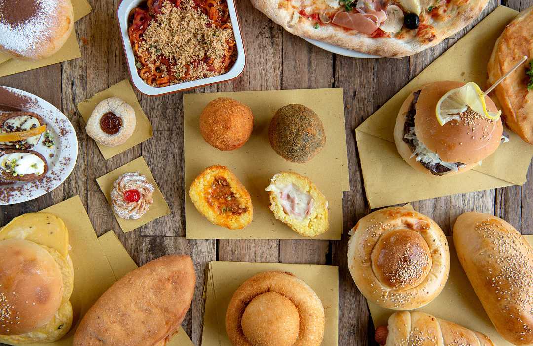 Selection of Sicilian street foods on a table in Sicily, Itlay