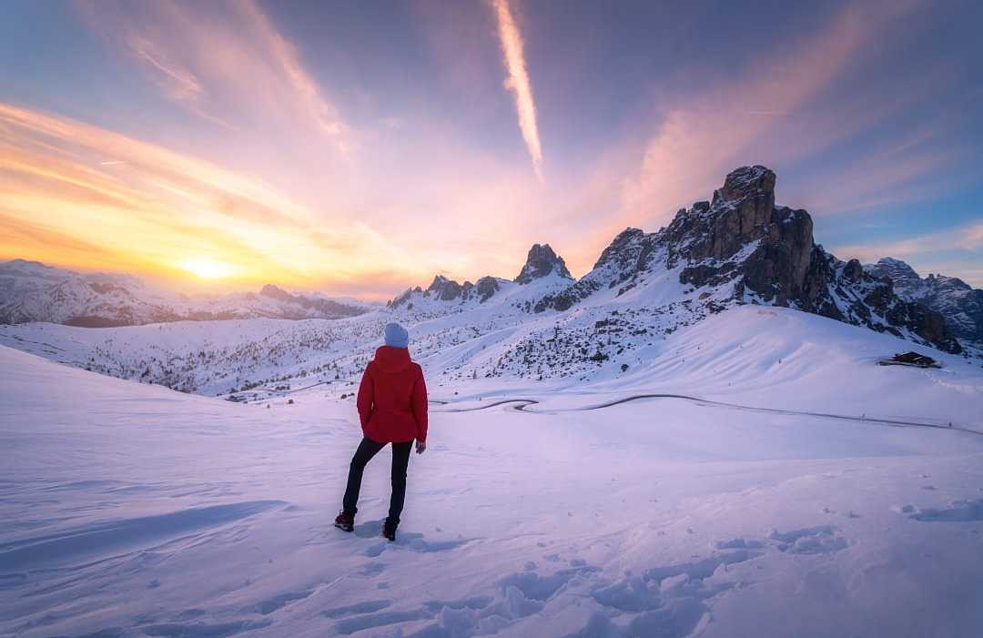 Woman hiking in the Dolomites during winter