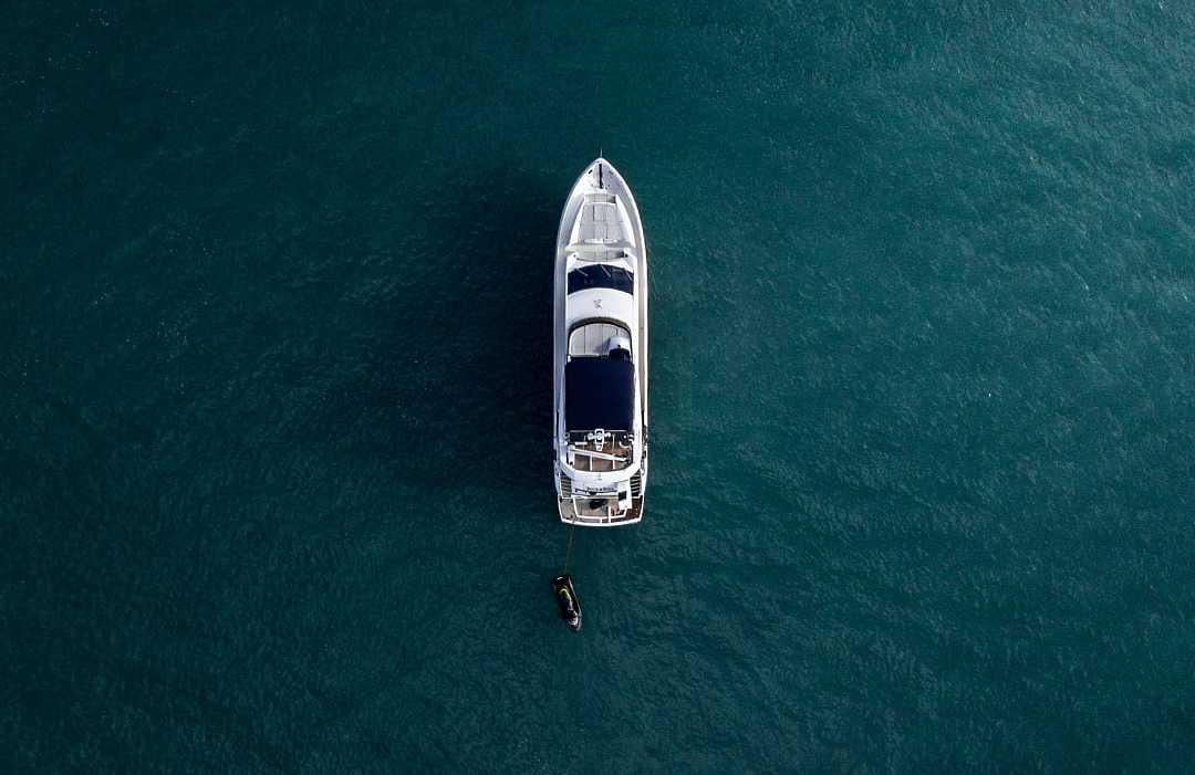 Aerial view of a luxury yacht anchored in turquoise water