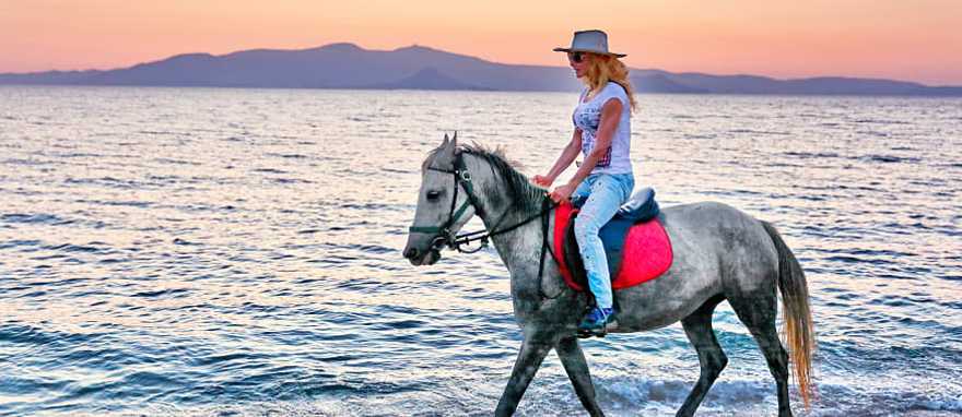 Horseback riding on the beach in Greece. Horseback riding on the beach in Greece.