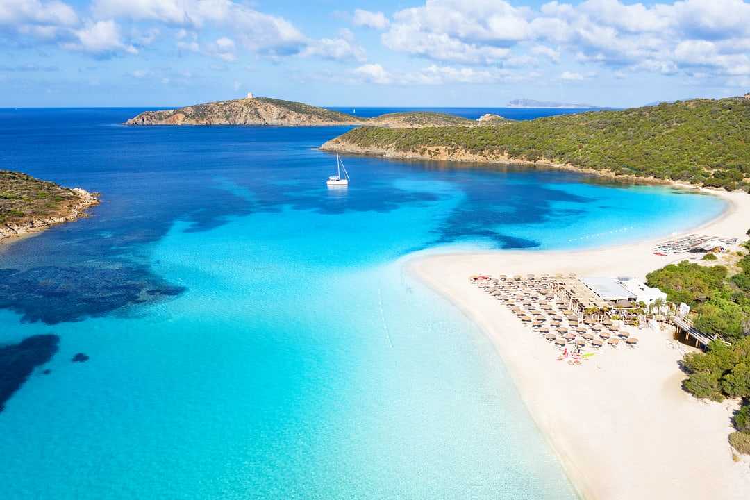 Clear blue waterof the Mediterrenean and golden sand at Tuerredda Beach in Tuerredda Beach in Sardinia, Italy