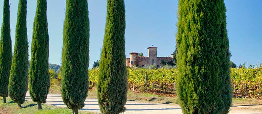Gabbiano Castle with vineyards and cypress trees in Tuscany, Italy