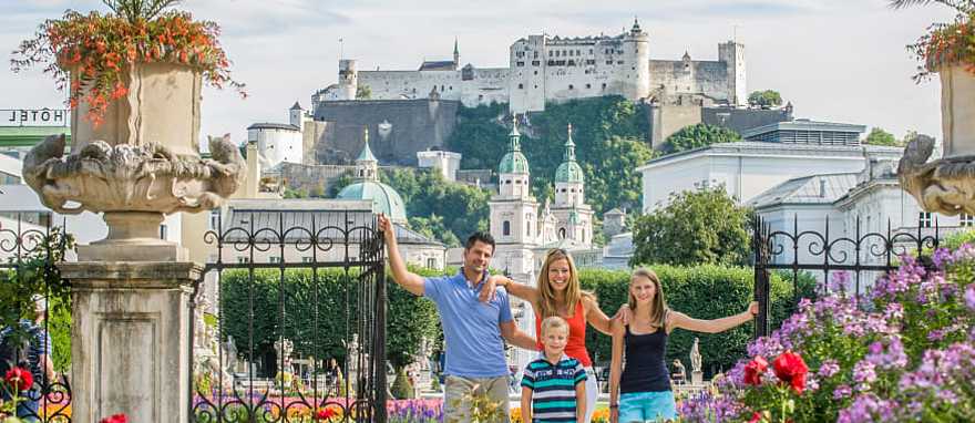 Family on vacation in Salzburg, Austria posing with Hohensalzburg in the background