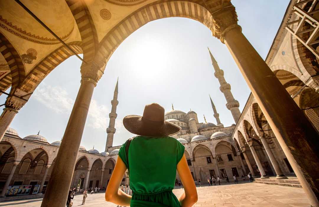 Blue Mosque in Istanbul, Turkey Woman visiting the Blue Mosque in Istanbul, Turkey
