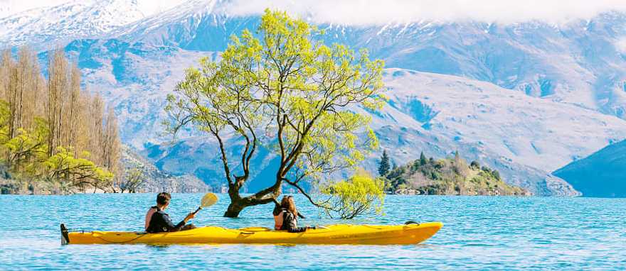 Couple kayaking Lake Wanaka in New Zealand Couple kayaking Lake Wanaka in New Zealand