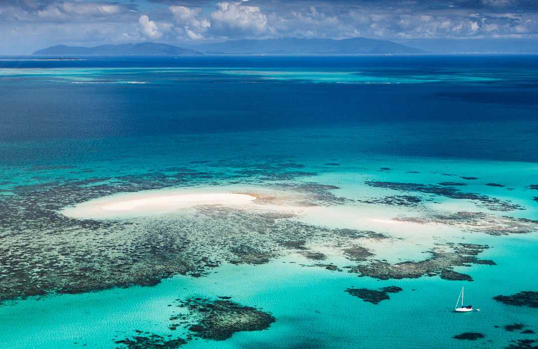 Breathtaking aerial view of the Great Barrier Reef, showcasing vibrant coral formations and turquoise waters in Queensland, Australia