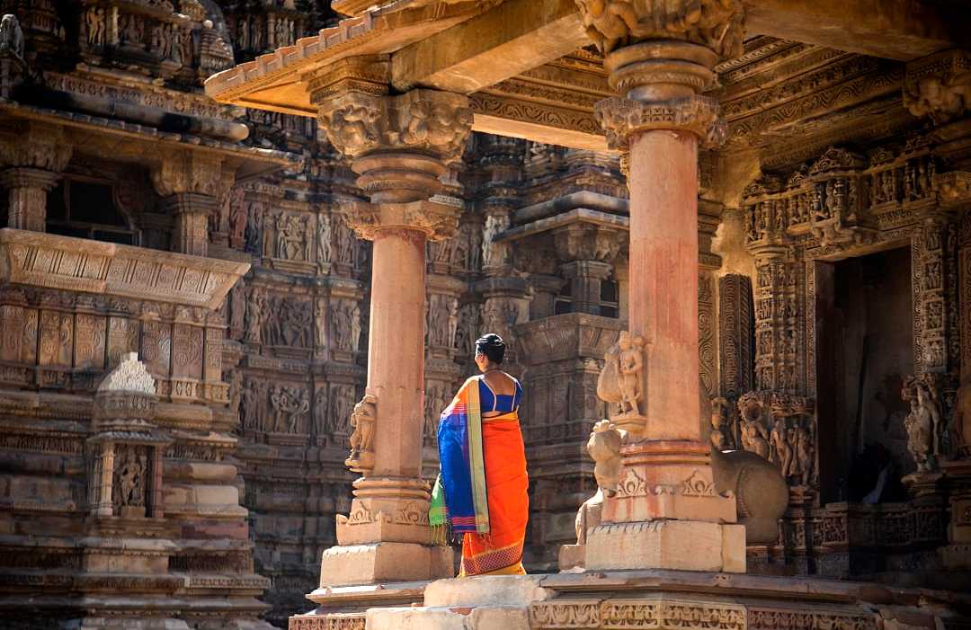 Indian women in colorful saree at Khajuraho Temple, UNESCO World Heritage Site, India.