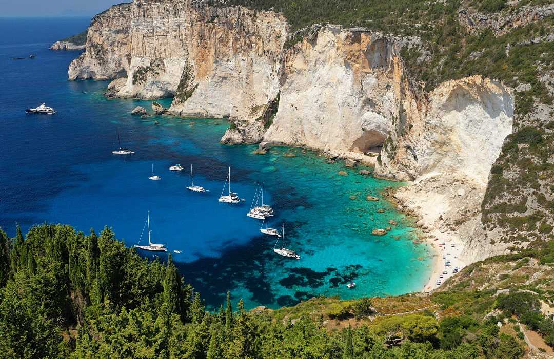 Boats moored at Erimitis Bay on Paxos Island, Greece