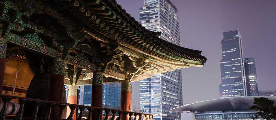 Traditional Bongeunsa Temple pavilion contrasting with the modern skyscrapers of Gangnam.