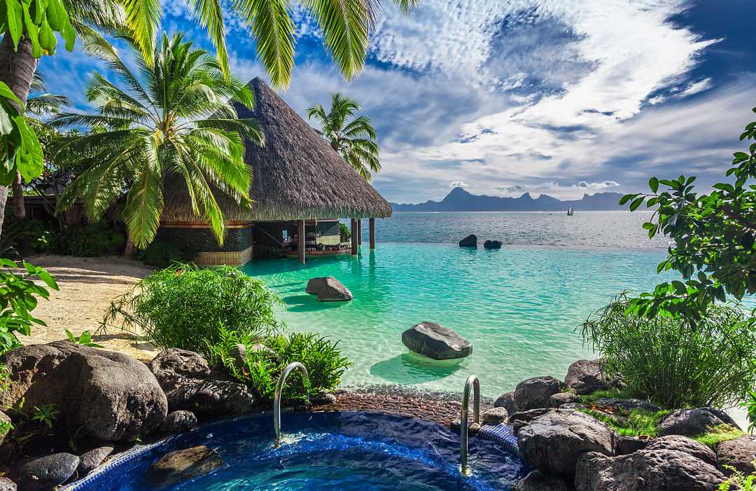 Infinity pool over tropical ocean in Tahiti. Infinity pool with jacuzzi over tropical ocean in Tahiti.