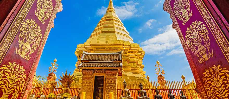 Golden temple framed by ornate archway at Wat Phra That Doi Duthep in Chiang Mai, Thailand