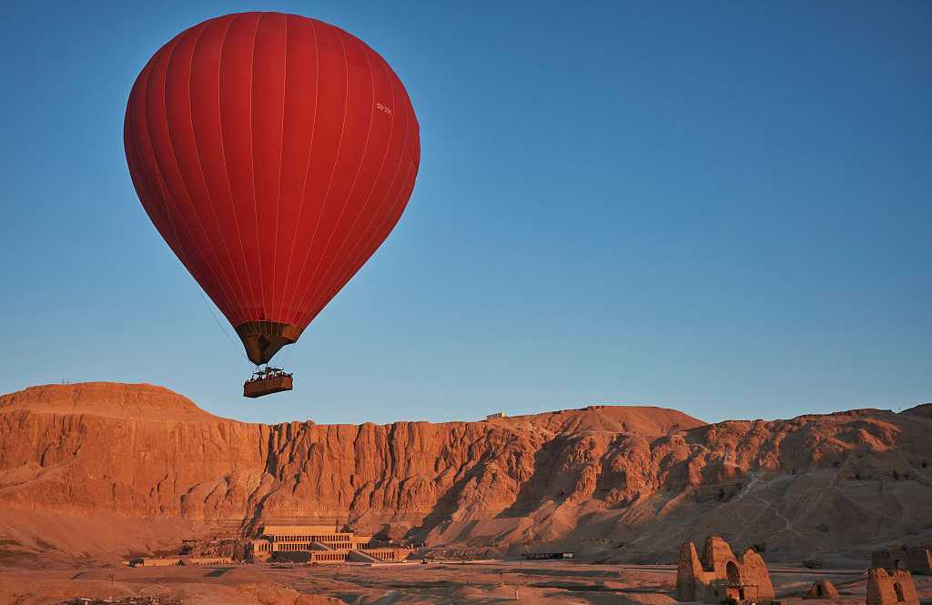 Temple of Hatshepsut in Deir el-Bahari, Egypt Hot air balloon over Asasif Valley and the Temple of Hatshepsut in Luxor, Egypt