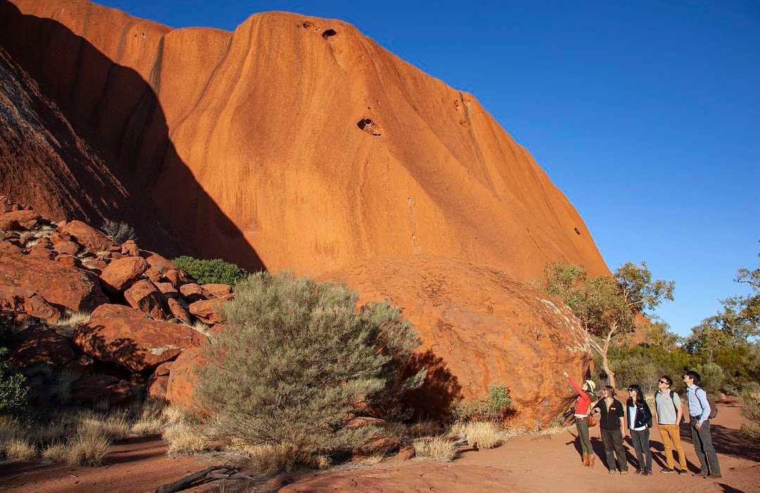 Uluru in the Northern Territory. Photo courtesy of Tourism Australia Family on private tour at Uluru in the Northern Territory, Australia