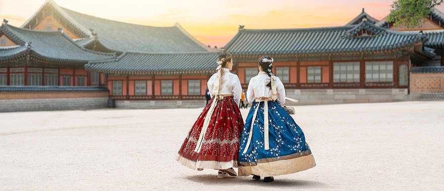 Women in hanbok stroll through the traditional-style homes in Seoul’s village. Women in hanbok stroll through the traditional-style homes in Seoul’s village.