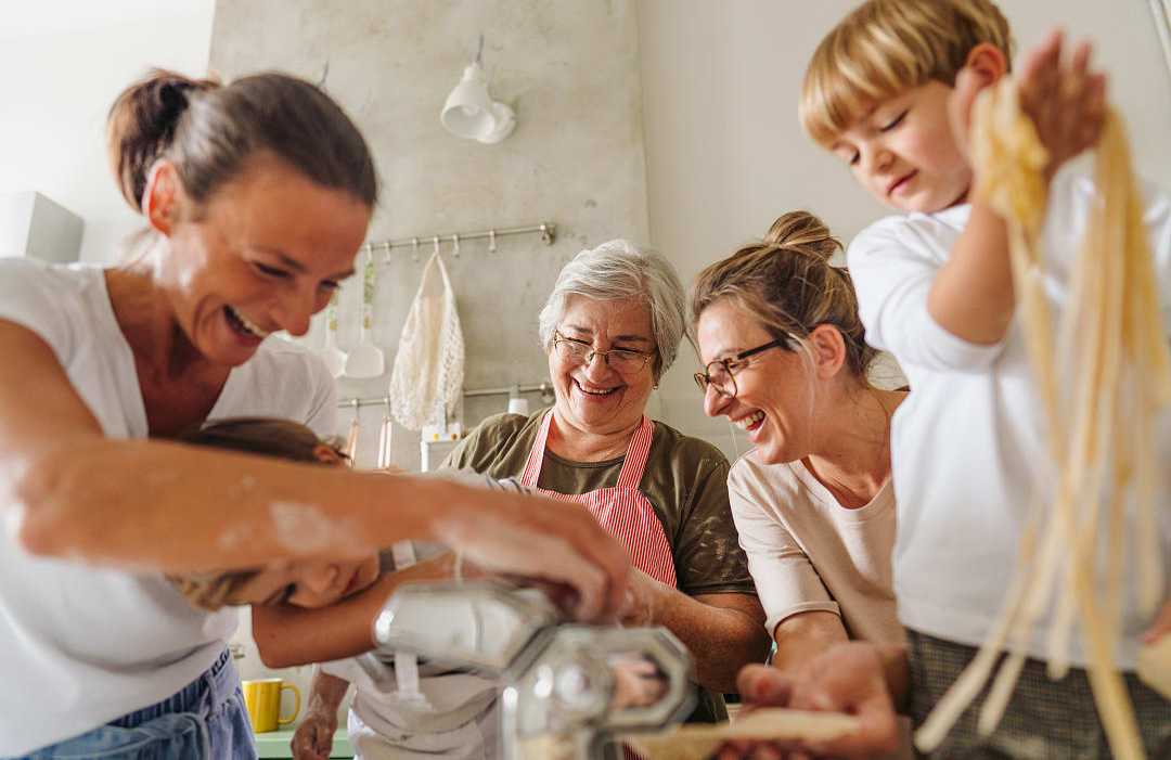 Family learning how to make pasta