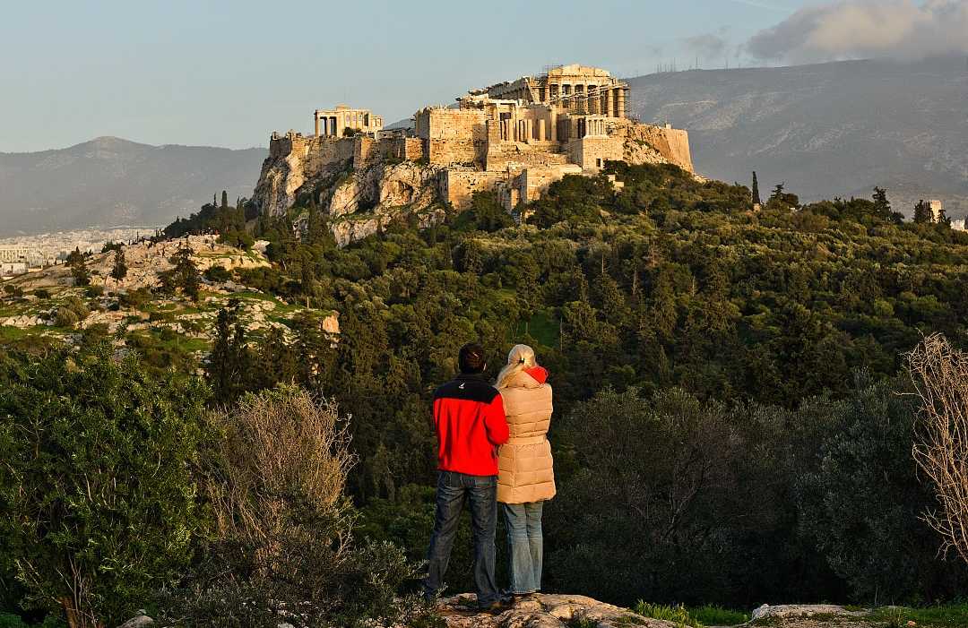A couple admires the Acropolis in Athens