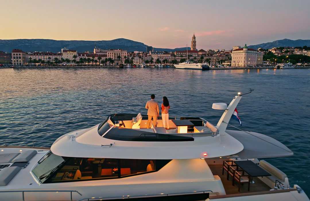 Split, Croatia Couple on a luxury yacht admiring the Split skyline during dusk in Croatia