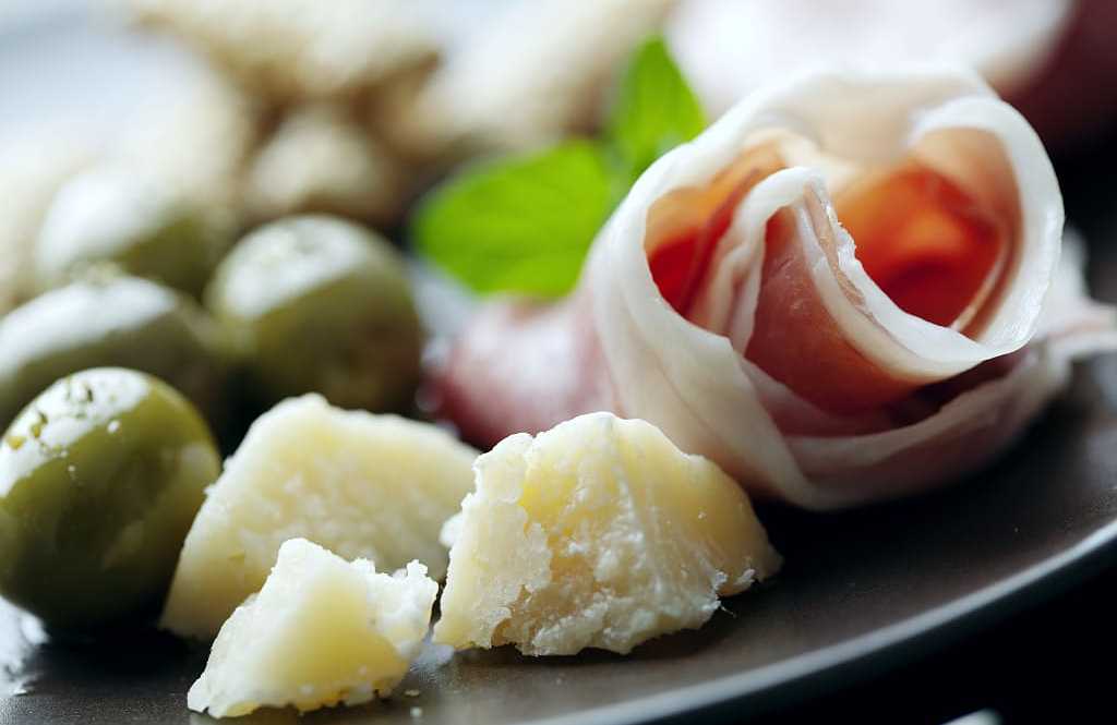 The famous Parma prosciutto and parmesan with green olives The famous Parma prosciutto and parmesan with green olives