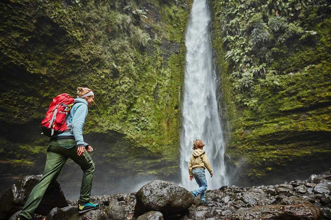 Mother and son on family vacation at Las Cascadas Waterfall in Chilean Patagonia