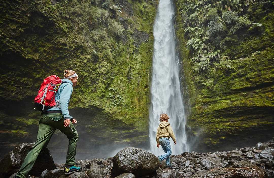 Las Cascadas Waterfall in Chilean Patagonia Mother and son on family vacation at Las Cascadas Waterfall in Chilean Patagonia