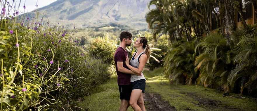 Couple with the Arenal volcano in the background in Costa Rica