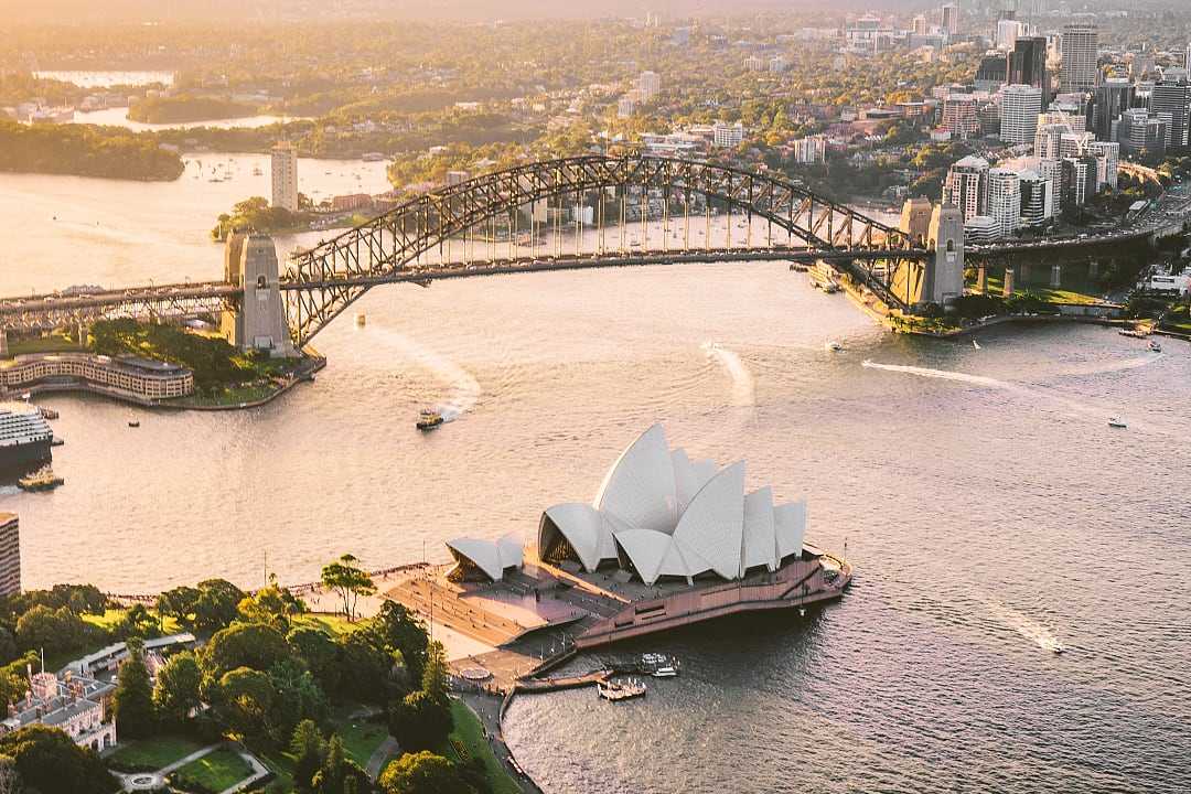 An aerial view of the Sydney Opera House, showcasing its iconic design against the harbor.