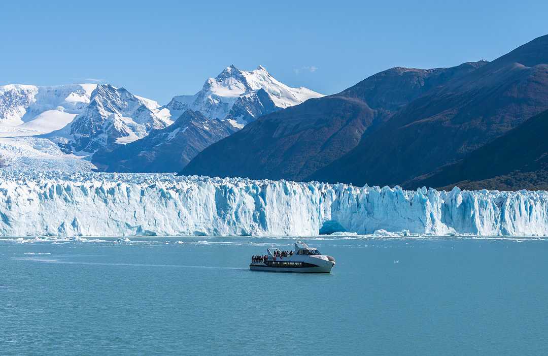 Ferry boat in front of Perito Moreno glacier in Argentina
